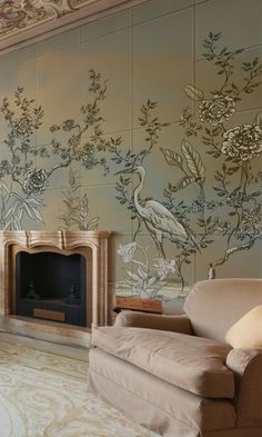 a living room with floral wallpaper and a fireplace