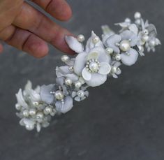 This elegant handmade white pearl floral crown is the perfect accessory for weddings, proms, or any special event.  Featuring delicate flowers crafted from resin, hand-painted in soft white and silver tones, and adorned with shimmering pearls, this bridal hairpiece exudes timeless beauty and sophistication.  Each flower is meticulously assembled on a flexible wire base, allowing the crown to fit comfortably and securely.  Ideal for brides, bridesmaids, or anyone seeking a vintage-inspired, boho look, this crown adds a touch of elegance and charm to any hairstyle. Flower Bridal Hair, Bridal Hair Accessories Flower, Pearl Hair Vine, Bridal Hairpiece, Bridal Hair Accessory, Bridal Hair Flowers, Delicate Flowers, Hair Vine, Wedding Headpiece