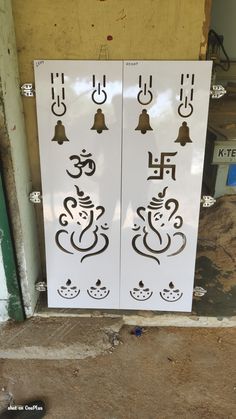 two white doors with black designs on them