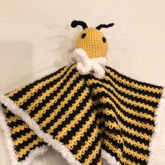 a crocheted yellow and black striped blanket