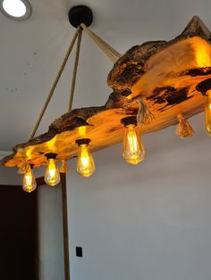 a light fixture made out of wood and hanging from the ceiling