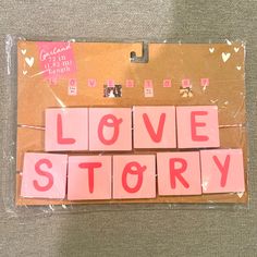 the word love story spelled with pink blocks