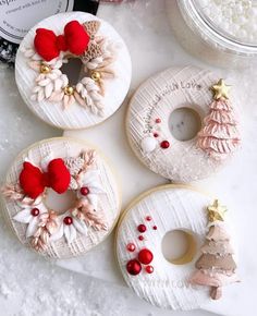 three decorated donuts sitting on top of a table