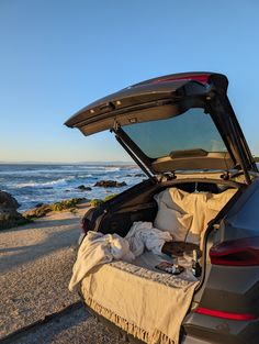 an open trunk of a car on the beach