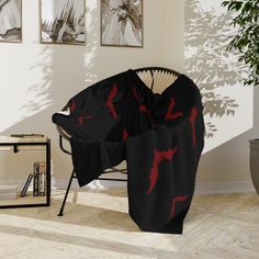 a chair covered with a black and red blanket