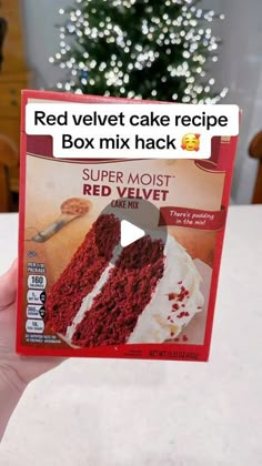 someone holding up a red velvet cake recipe box