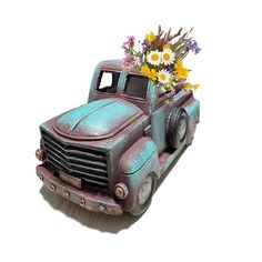 an old truck with flowers in the bed is painted blue and has purple tint