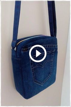 a blue purse hanging on the wall with an arrow pointing to it's pocket