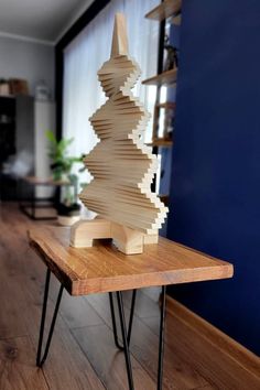 a wooden christmas tree sitting on top of a table