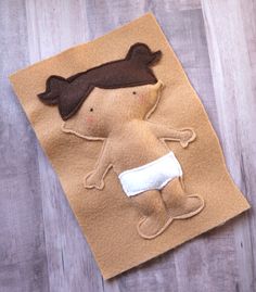 a brown felt doll with a white diaper