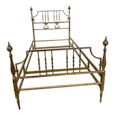 an antique brass bed frame with metal posts