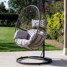 an outdoor swing chair with cushions on it