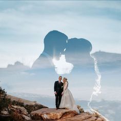 a bride and groom standing on top of a mountain