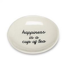 a white plate with the words happiness is a cup of tea written in black on it