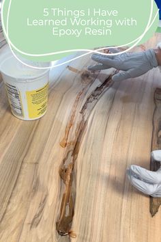 a person in white gloves is working with epox resin on a wooden surface and the words, 5 things i have learned working with epox resin resin