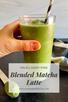 a hand holding a green smoothie with a straw in it and text overlay reading paleo dairy free blended matcha latte