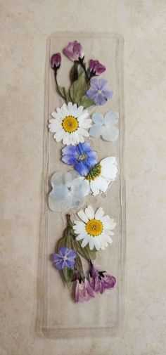 some flowers are laying on top of a plastic container with water in the bottom half