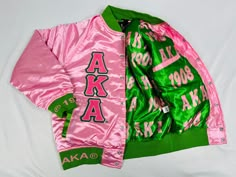 a pink and green jacket with the letters aka on it