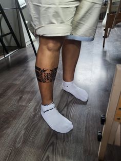 a person with tattoos on their legs wearing white socks