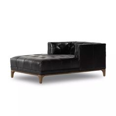 a black leather chaise lounge chair with wooden legs