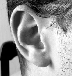 black and white photograph of a man's ear