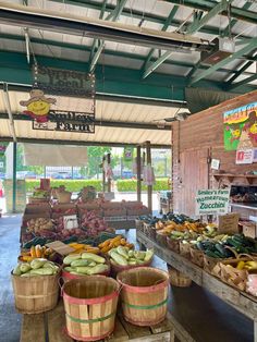 an open air market with lots of fruits and veggies on display in baskets