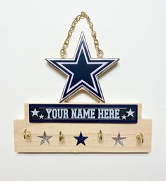 a wooden sign that says your name here with three stars hanging from it's side