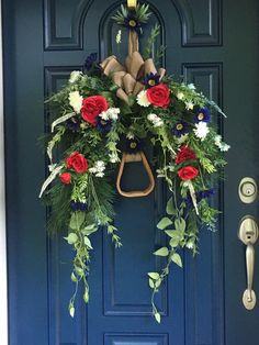 a blue front door with a wreath on it and an umbrella hanging from the handle