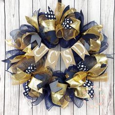 a gold and blue wreath with the number twenty five on it sitting on a wooden surface