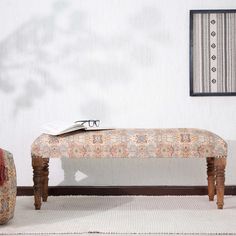 a wooden bench sitting on top of a rug