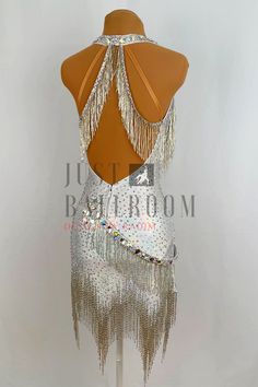 the back of a woman's dress with fringes and sequins on it