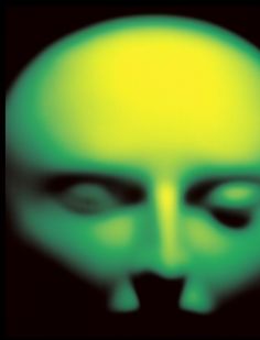 an image of a green alien face in the dark