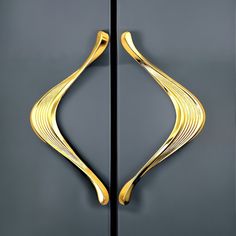 two metal doors with gold designs on them