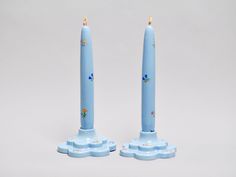 two blue candles sitting on top of each other