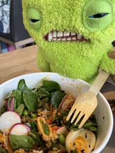 a stuffed animal is sitting next to a bowl of food and a fork in it