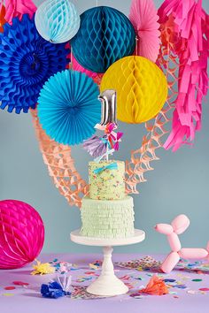 a birthday cake surrounded by decorations and streamers