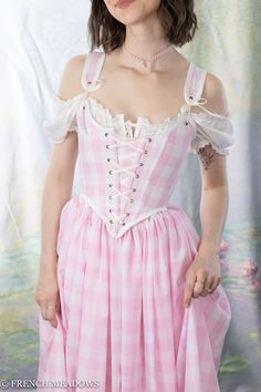 Transform into a living doll with the Pink Gingham Renaissance Corset! This stunning corset is inspired by Barbie's iconic style and is perfect for anyone looking to bring some fun and glamour to their style. Made from high-quality materials, the corset features a beautiful pink gingham pattern that is both cute and sophisticated. The corset is carefully constructed with boning for added support and shape, and includes a front lacing closure that allows for a customizable fit. Whether you're att I Love Lucy Corset, Medieval Corset Dress Pink, Princess Corset, Cottagecore Princess, Fair Outfits, Princess Fashion, Pink Corset, Gingham Skirt, Cottagecore Style