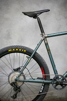 a close up of a bike on a gray background with the words maxx written on it