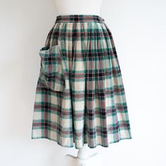 A very cute 1950s tartan corduroy midi skirt. It has one giant pocket and a metal zip at the side as well as a hook & eye at the top.  A few small marks that get lost in the print and fabric.  Waist: 27" Length: 27" ♥ SHIPPING ♥ * International postage - these costs are estimates, and I will happily refund any excess postage you may have paid once I have posted the item. * * UK postage - all items will be sent via Royal Mail* ♥ DESCRIPTIONS ♥ I thoroughly inspect all of my items and aim to descr Vintage Plaid Full Skirt, Vintage Plaid Cotton Skirt, Retro Plaid Cotton Skirt, Tartan Midi Skirt, Corduroy Midi Skirt, Midi Skirt With Pockets, Womens Skirts, Vintage Clothing Online, Hook Eye