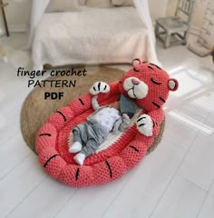 a crochet pattern for a baby in a bed that looks like a tiger