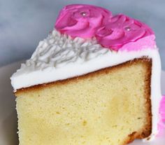 a piece of cake with white frosting and pink flowers