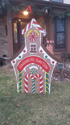 a gingerbread house sign in front of a home