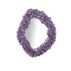 an oval shaped mirror made out of purple crystals