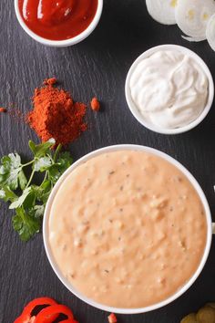 the ingredients to make this dip are in small white bowls and on top of each other