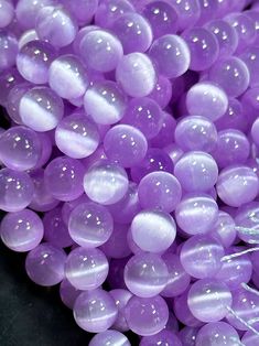 purple beads are piled on top of each other