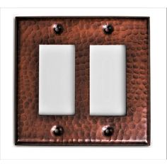 two light switch plates in copper with white inserts