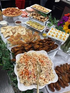 a table filled with lots of food and desserts