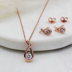 Nothing says style quite like the classic Rose Gold plated Sterling Silver Love Knot necklace, set with sparkling cubic zirconia, it makes a gorgeous necklace for every occasion. Matching earrings are also available. PRODUCT INFO: 925 Sterling silver with Rose Gold vermeil. Cubic zirconia stone Height: 15.00mm Width: 8.00mm Depth: 3.00mm Chain Length: Apx 45cm PACKAGING - For that extra special finishing touch, all Lovey Dovey Jewellery is beautifully presented inside a free luxury box. DELIVERY Gold Earrings Pendant Set, Gold Chain With Earrings Set, Pendant With Earrings Gold, Pendant And Earrings Set Gold, Pendent Designs Gold, Pendent Set Gold, Mangalsutra Pendent, Rose Gold Jewelry Earrings, Rose Gold Pendant Set