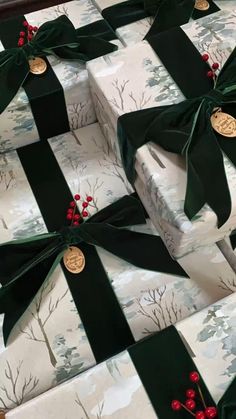 several wrapped presents with green bows and red berries