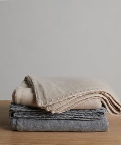 three folded linens stacked on top of each other